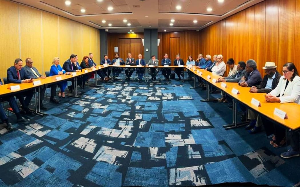 Group photo of participants at the end of negotiations