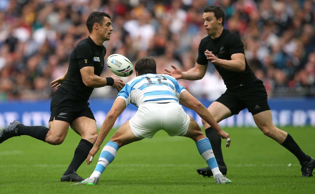 Dan Carter offloads the ball to Ben Smith in the All Blacks World Cup match with Argentina.
