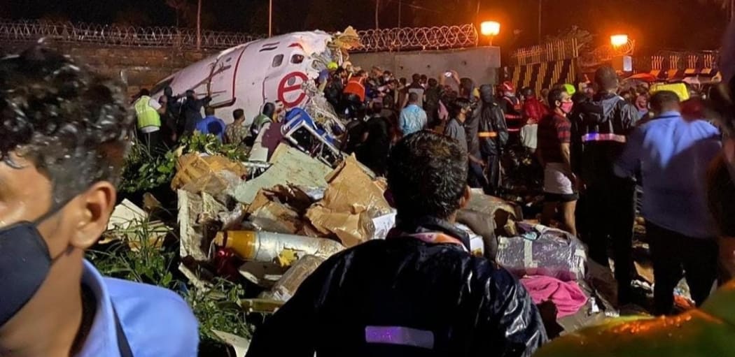 KERALA, INDIA - AUGUST 07: Teams conduct search and rescue operation at the site after an Air India Express passenger plane with 191 passengers onboard skidded off the runway in the southern Indian state of Kerala on August 07, 2020.