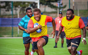 Tevita Ikanivere on the run with Luke Tagi in support at training in Marseille.