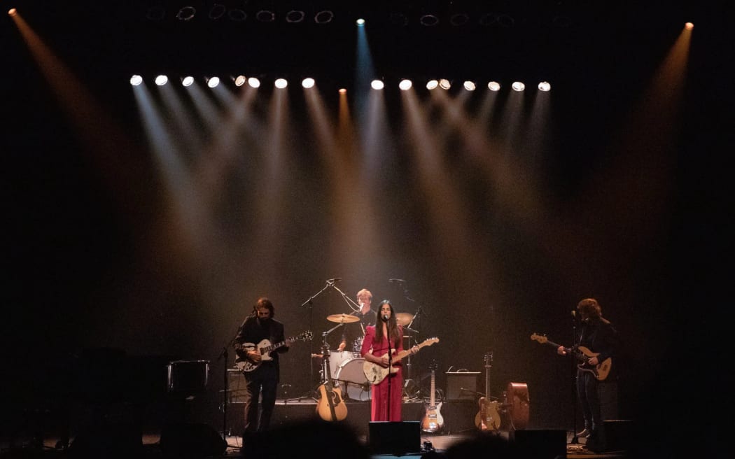 Mel Parsons and band performing at Isaac Theatre