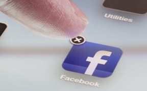 Adelaide, Australia - October 3, 2012: Deleting the Facebook app from an iPad by clicking the cross at the corner of the icon for the app.