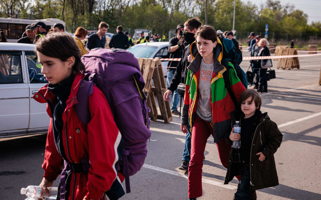 A family evacuated from Mariupol's Azovstal plant arrive at a registration and processing area for internally displaced people in Zaporizhzhia on 3 May. The UN said 101 refugees had been evacuated with the Red Cross by Tuesday.