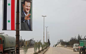 A poster of Syrian President Bashar al-Assad adorning the M5 highway connecting Aleppo to Damascus on February 18, 2020.