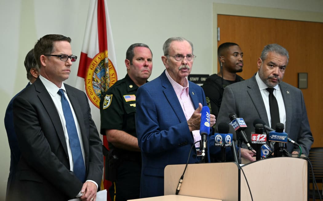 Palm Beach County Sheriff Ric Bradshaw, centre, speaks alongside Jeffrey Veltri, left, special agent in charge of the Miami Field Office of the FBI and Rafael Barros, special agent in charge of the US Secret Service's Miami field office, following a shooting incident at former US president Donald Trump's golf course.