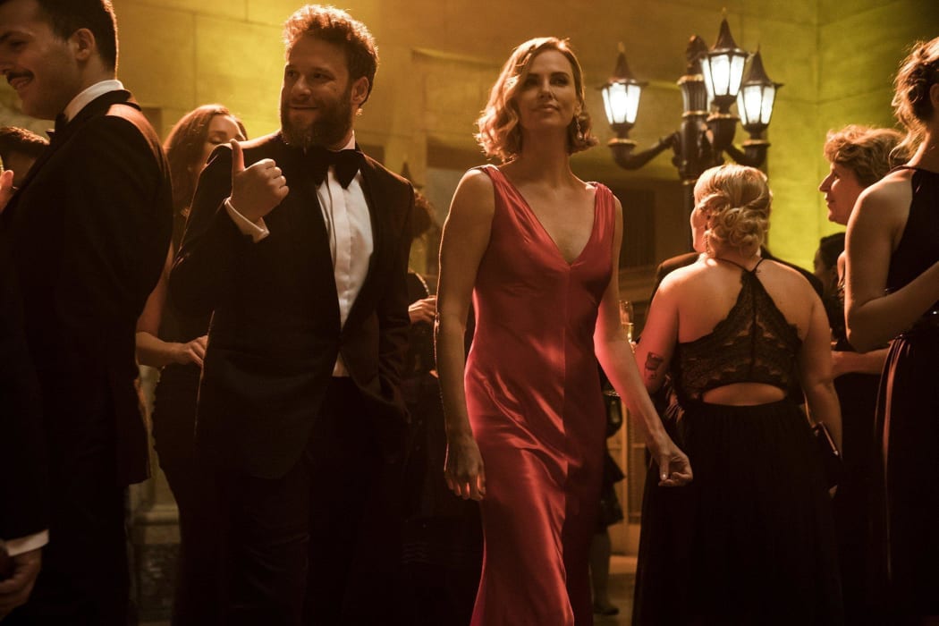 Seth Rogen gets a bit of a makeover once he joins the staff of the Secretary of State (Charlize Theron). Ms Theron doesn’t appear to need one.