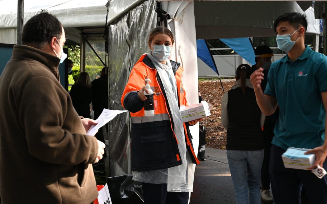 Sydneysiders queue outside a vaccination centre in Sydney on June 29, 2021, as about 10 million Australians have been ordered into lockdown as Covid-19 spreads across the country,