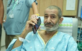 A handout image made available by the Israeli Prime Minister's office on August 27, 2024, shows freed Israeli hostage Kaid Alkadi talking on the phone after arriving for a checkup at the Soroka Medical Center in Beersheva. The Israeli military said its forces rescued an Israeli hostage in southern Gaza on August 27 after a "complex operation" as the war between Israel and Hamas, now in its 11th month, showed no signs of abating. (Photo by Israeli Prime Minister's Office / AFP) / RESTRICTED TO EDITORIAL USE - MANDATORY CREDIT "AFP PHOTO / ISRAELI PRIME MINISTER'S OFFICE' - NO MARKETING NO ADVERTISING CAMPAIGNS - DISTRIBUTED AS A SERVICE TO CLIENTS