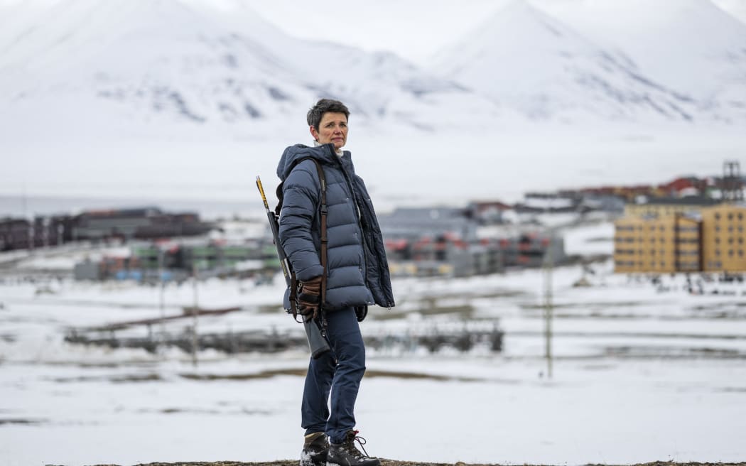 Siv Limstrand, the priest at Svalbard church, with her rifle over her shoulder, in Longyearbyen, Spitsbergen island, Svalbard Archipelago, northern Norway, on 6 May, 2022.