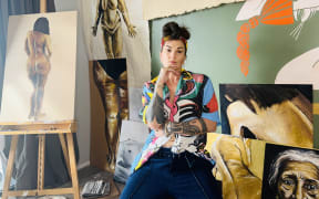 Hollie Smith in the studio with her artworks.