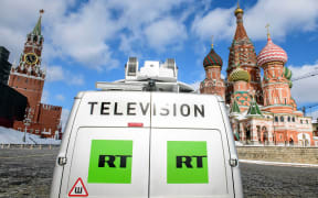 A Russia's state-controlled Russia Today (RT) television broadcast van is seen parked in front of St. Basil's Cathedral.