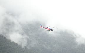 Rescue helicopter attends to the last three fatal crash victims on Fox Glacier.