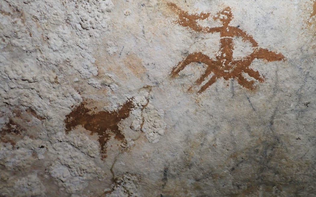 Faded hand shape in Indonesian cave may be world’s oldest rock art.