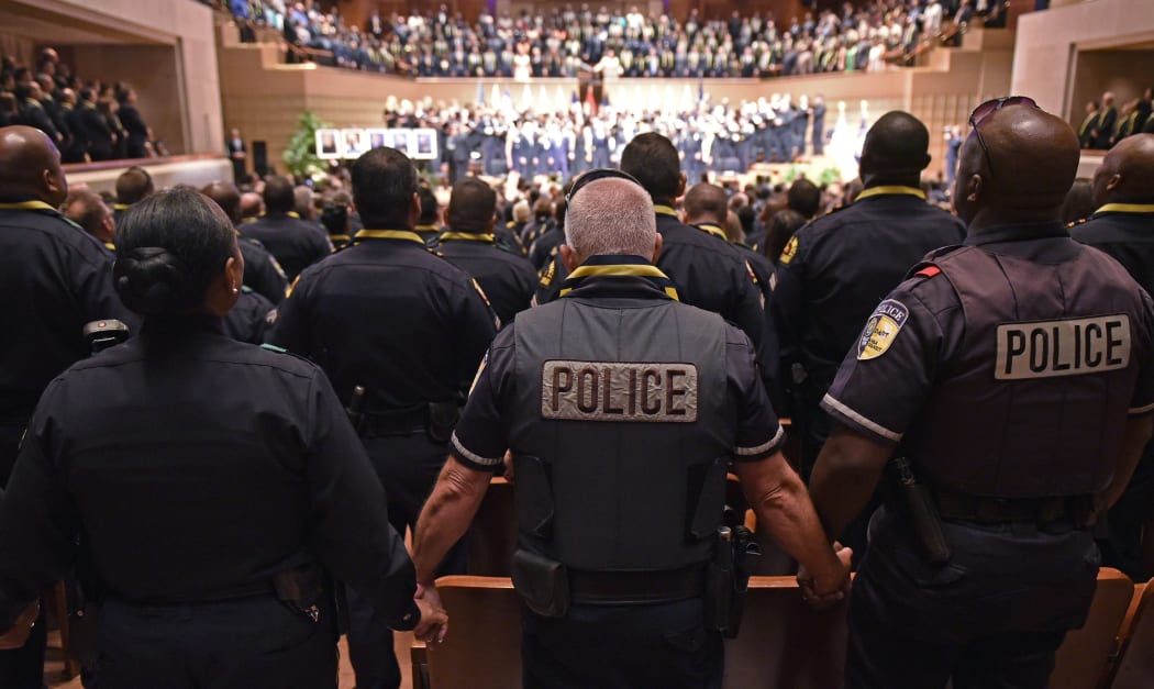 Police join hands during the singing of "The Battle Hymn of the Republic"