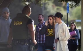 People arrive to a family assistance and reunification center following a mass shooting at the Borderline Bar and Grill.