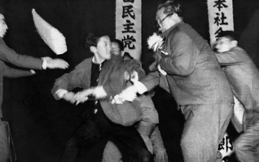 Photo dated October 1960 of Japanese Socialist Party (JSP) chairman Inejiro Asanuma (R) assassinated on live television while giving a speech at a political debate.  He was stabbed to death by Otoya Yamaguchi (L) a 17-year-old student. (Photo by AFP / AFP)