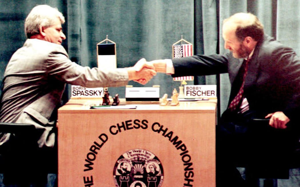 (FILES) Russian-born chess master Boris Spassky (L) shakes hands with US master Bobby Fischer (R) at the beginning of their first match in the Hotel Maestral in Sveti Stefan, on September 2, 1992. The Russian Chess Federation announced on February 27, 2025, that the Russian grandmaster Boris Spassky had died. (Photo by AFP)