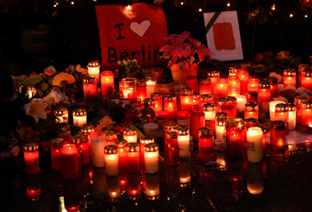 candles lie on the ground at the Christmas market on Breitscheidplatz square in Berlin, Germany, 22 December 2016.