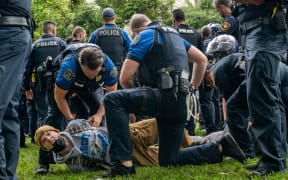 AUSTIN, TEXAS - APRIL 24: A student is arrested during a pro-Palestine demonstration at the The University of Texas at Austin on April 24, 2024 in Austin, Texas. Students walked out of class and gathered in protest during a pro-Palestine demonstration. Protests continue to sweep college campuses around the country.   Brandon Bell/Getty Images/AFP (Photo by Brandon Bell / GETTY IMAGES NORTH AMERICA / Getty Images via AFP)