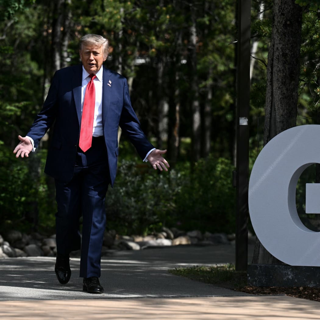 US President Donald Trump gestures during an arrival ceremony at the Group of Seven (G7) Summit at the Pomeroy Kananaskis Mountain Lodge in Kananaskis, Alberta, Canada on June 16, 2025. (Photo by Brendan SMIALOWSKI / AFP)