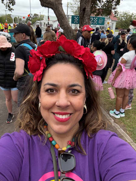 Nicole Retter smiling while taking a selfie in a crowd.