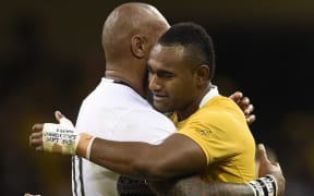 Cousins Tevita Kuridrani (Australia) and Nemani Nadolo (Fiji) embrace following their team's Rugby World Cup clash in Cardiff.