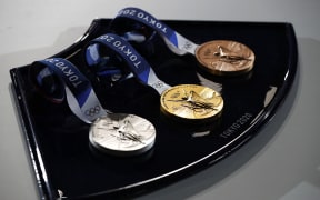 The medals and tray to be used for the medal ceremonies at the Tokyo 2020 Olympics Games are seen during an event to mark 50 days to the opening ceremony, at Ariake Arena in Tokyo on June 3, 2021.