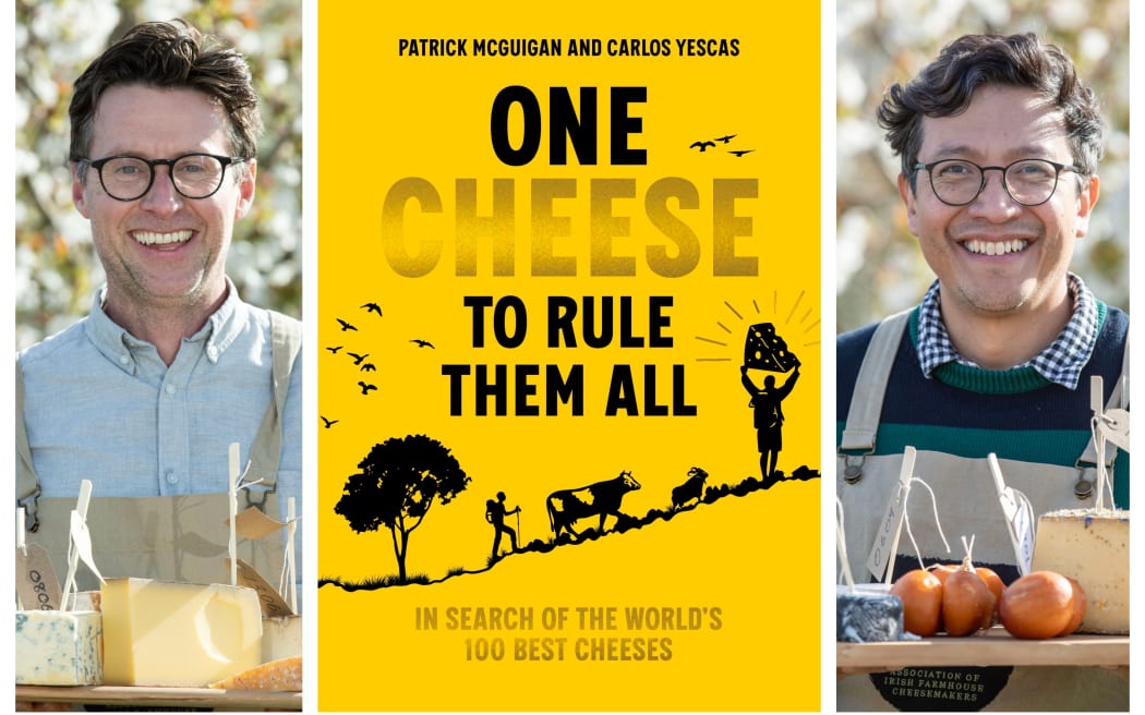 Patrick McGuigan & Carlos Yescas both hold a wooden tray full of different types of cheese. The book cover for 'One Cheese to Rule Them All' is laid out between them.