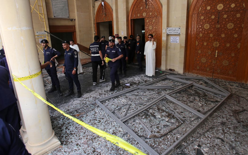 Kuwaiti security forces gather outside the Shiite Al-Imam al-Sadeq mosque after it was targeted by a suicide bombing.