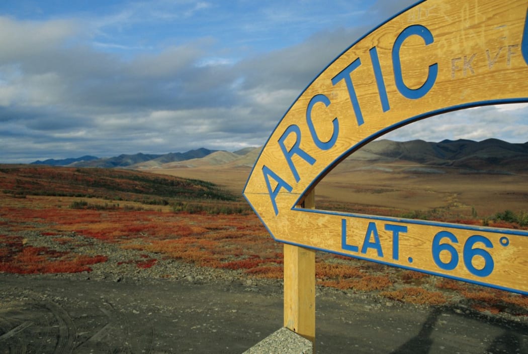 Arctic Circle crossing point on road across tundra, Dempster Highway, Yukon, Canada