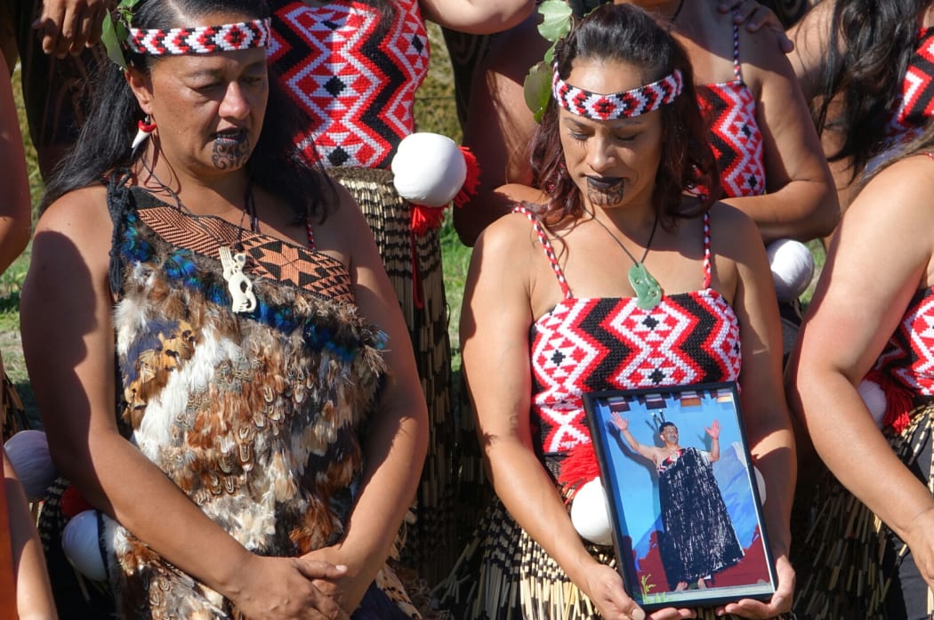 Te Waka Huia members holding a photo of Dr Ngapo Wehi.