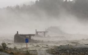 The Waiho Bridge has been totally taken out by the raging floodwaters.