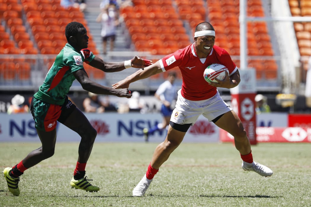 Tonga's Tana Fotofili evades the Kenyan defence in Sydney.