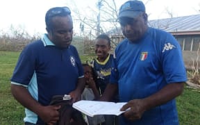 Richard Jenery Senior and Junior look at their community disaster assessment list