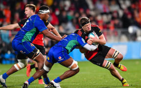 Scott Barrett of the Crusaders is tackled by Joseva Tamani of Fijian Drua during the Super Rugby Pacific match, Crusaders Vs Fijian Drua, at Orangetheory Stadium, Christchurch, New Zealand, 20th May 2022. Copyright photo: John Davidson / www.photosport.nz