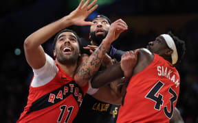 Jontay Porter #11 and Pascal Siakam #43 of the Toronto Raptors push on Anthony Davis #3 of the Los Angeles Lakers during an NBA game, 2024.