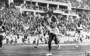 US athlete Jesse Owens crossing the finish line to win the 100 metre and setting a new world record at the Berlin Olympics in 1936.
