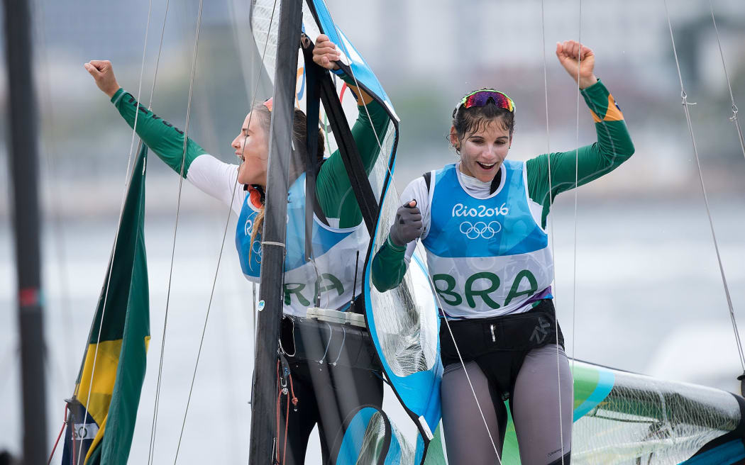 Brazil’s Martine Grael and Kahena Kunze celebrate winning Gold for the 49er class sailing race the 2016 Rio Olympics on Thursday the 18th of August 2016. © Copyright Photo by Marty Melville / www.Photosport.nz