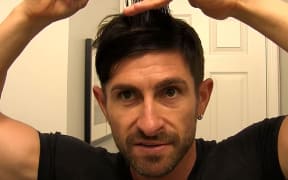 man cutting his own hair