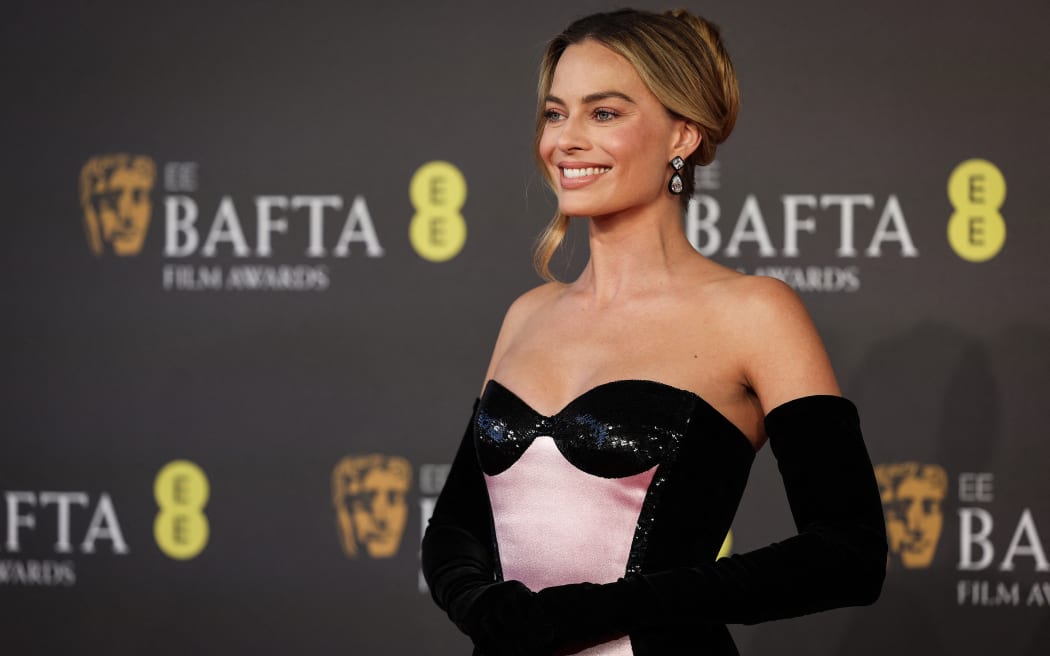 Australian actress Margot Robbie poses on the red carpet upon arrival at the BAFTA British Academy Film Awards at the Royal Festival Hall, Southbank Centre, in London, on February 18, 2024. (Photo by Adrian DENNIS / AFP)