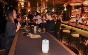 Patrons enjoy a drink in Nick & Nora's bar at a midnight opening in Melbourne on October 28, 2020 after the state government lifted some of the city's harsh restrictions.