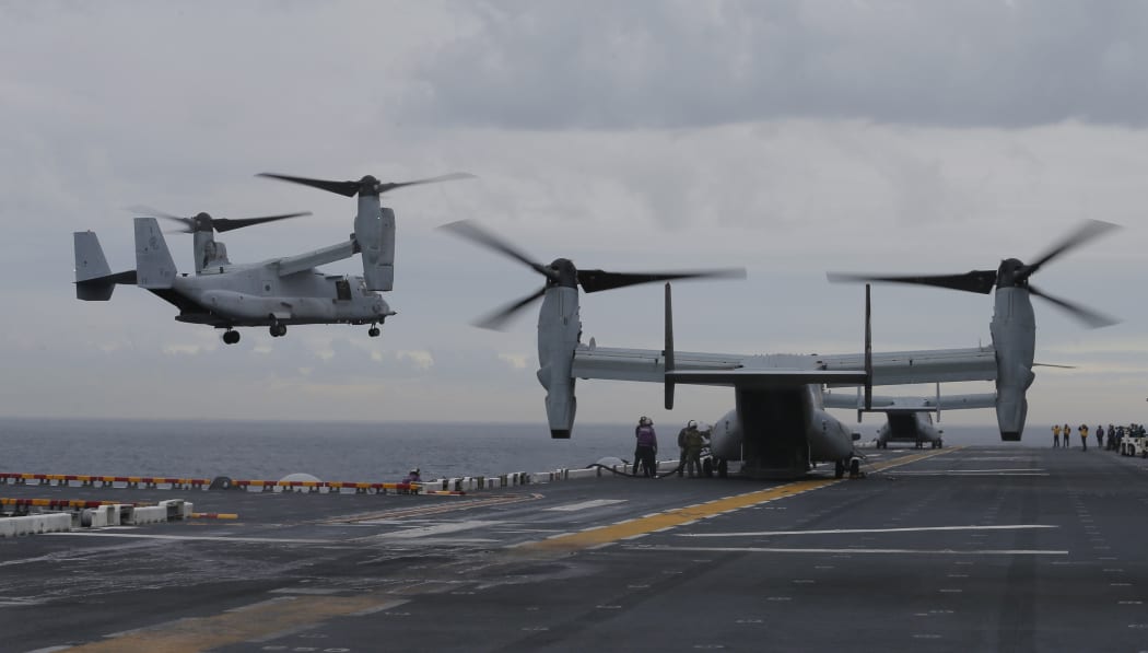 Osprey aircraft take off from the deck of amphibious assault ship the USS Bonhomme Richard during the Talisman Sabre exercise