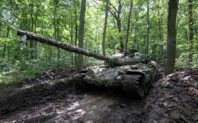 A tank from Ukraine's 3rd Independent Tank Iron Brigade is seen at a position near the front line in Kharkiv region, on June 15, 2023, amid the Russian invasion of Ukraine. Kyiv on June 15, 2023 reported progress in its counteroffensive on the eastern and southern fronts, despite contending with strong resistance from Russian troops. (Photo by SERGEY BOBOK / AFP)