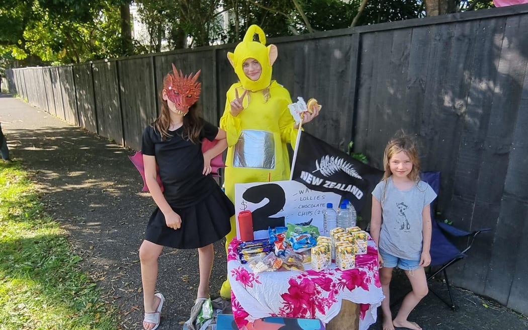 Evie Taylor, Tilly Teiry and Billie Lane selling snacks ahead of the Rugby World Cup final between the Black Ferns and England on 12 November, 2022.