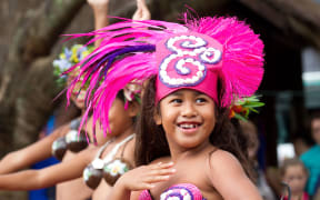 Children perform traditional dances during a visit by US Secretary of State Hillary Clinton at the Avarua markets in Rarotonga, Cook Islands on September 1, 2012.