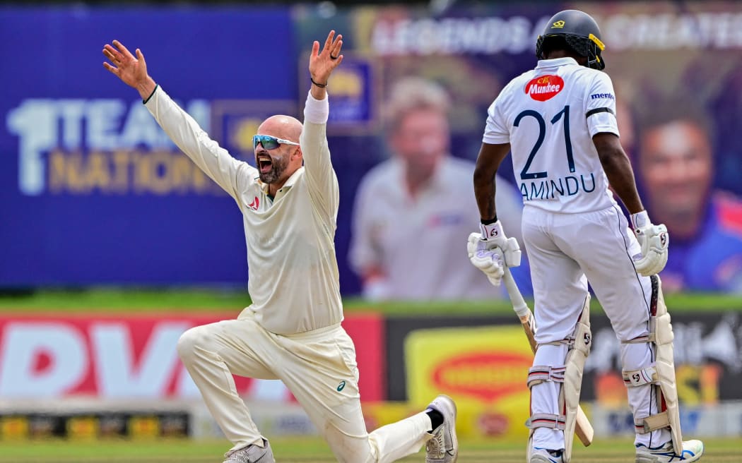 Australia's Nathan Lyon (L) successfully appeals for leg before wicket (LBW) against Sri Lanka's Angelo Mathews during the fourth day of the first Test cricket match between Sri Lanka and Australia at the Galle International Cricket Stadium in Galle on February 1, 2025. (Photo by Ishara S. KODIKARA / AFP)