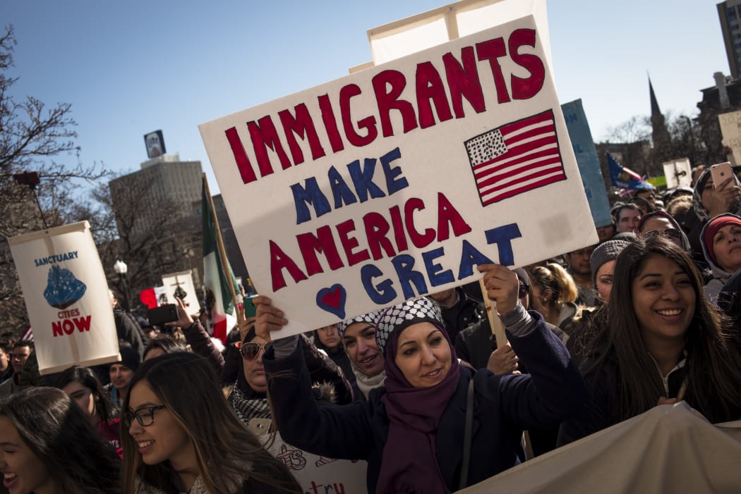 Protestors march in opposition to President Trump's executive order temporarily banning visa holders from seven Muslim-majority countries.