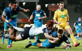Blues midfielder Piers Francis crashes over for one of the Blues five tries.