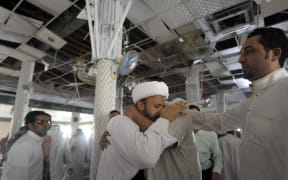 A Saudi man reacts following the blast at the mosque in Qatif on 22 May.