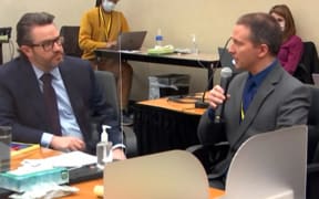 This screenshot from Court TV shows former Minneapolis police officer Derek Chauvin, right, sitting next to defence attorney Eric Nelson, as he tells the presiding judge he has decided not to testify in his own defence.